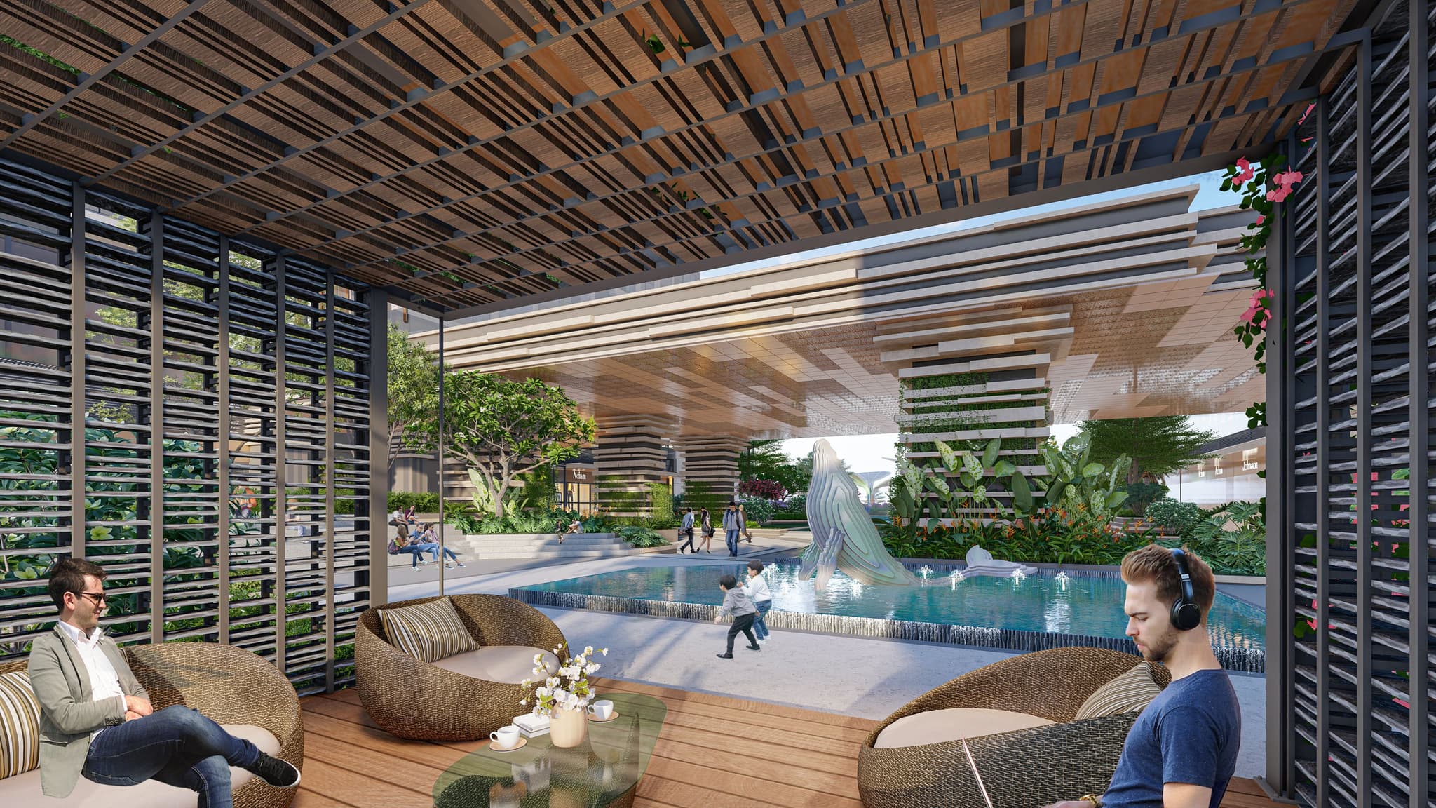 Modern outdoor lounge with seating and a fountain, featuring people relaxing and a lush garden view.