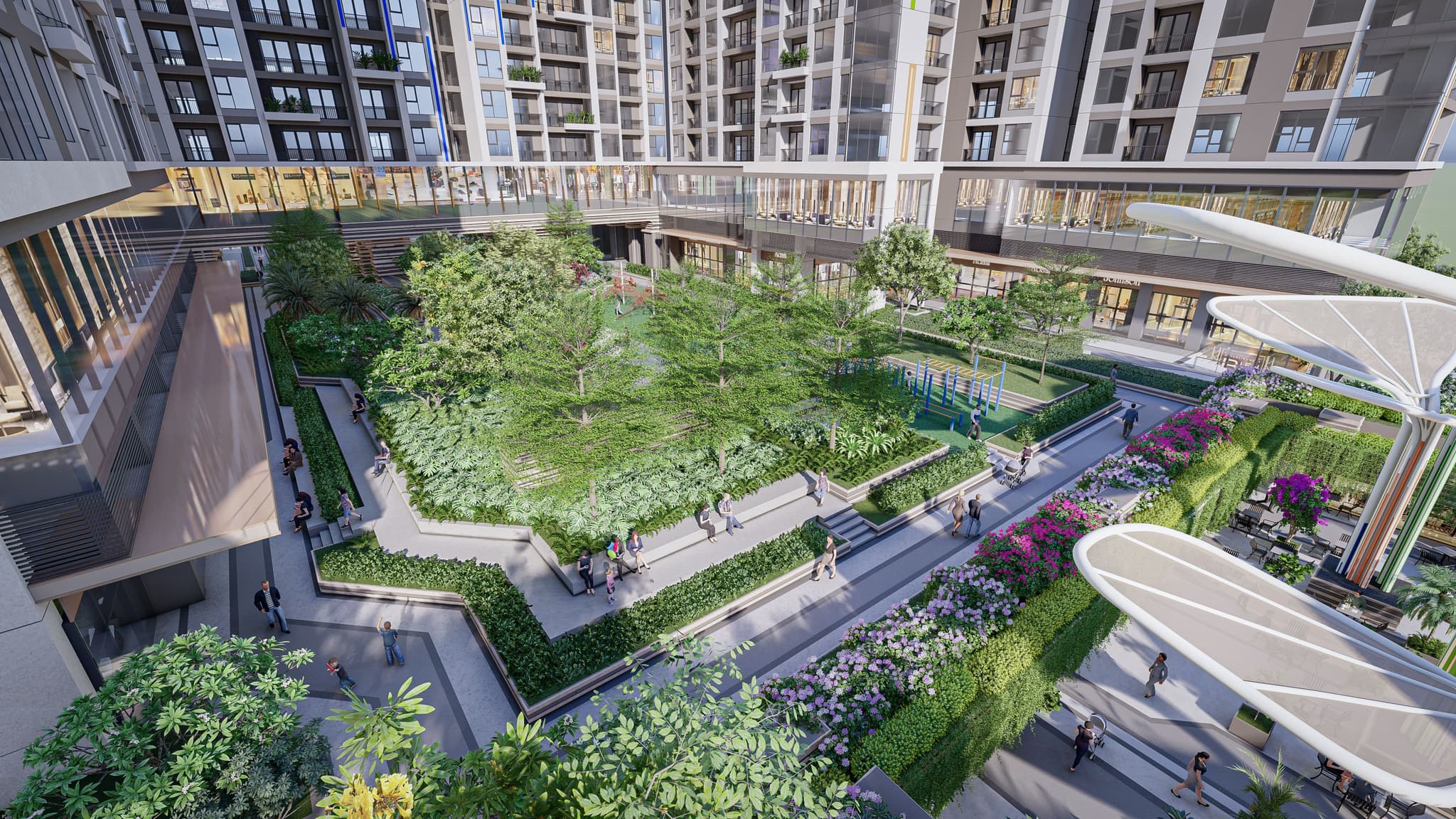Lush green courtyard surrounded by modern apartment buildings, featuring pathways and landscaped gardens.