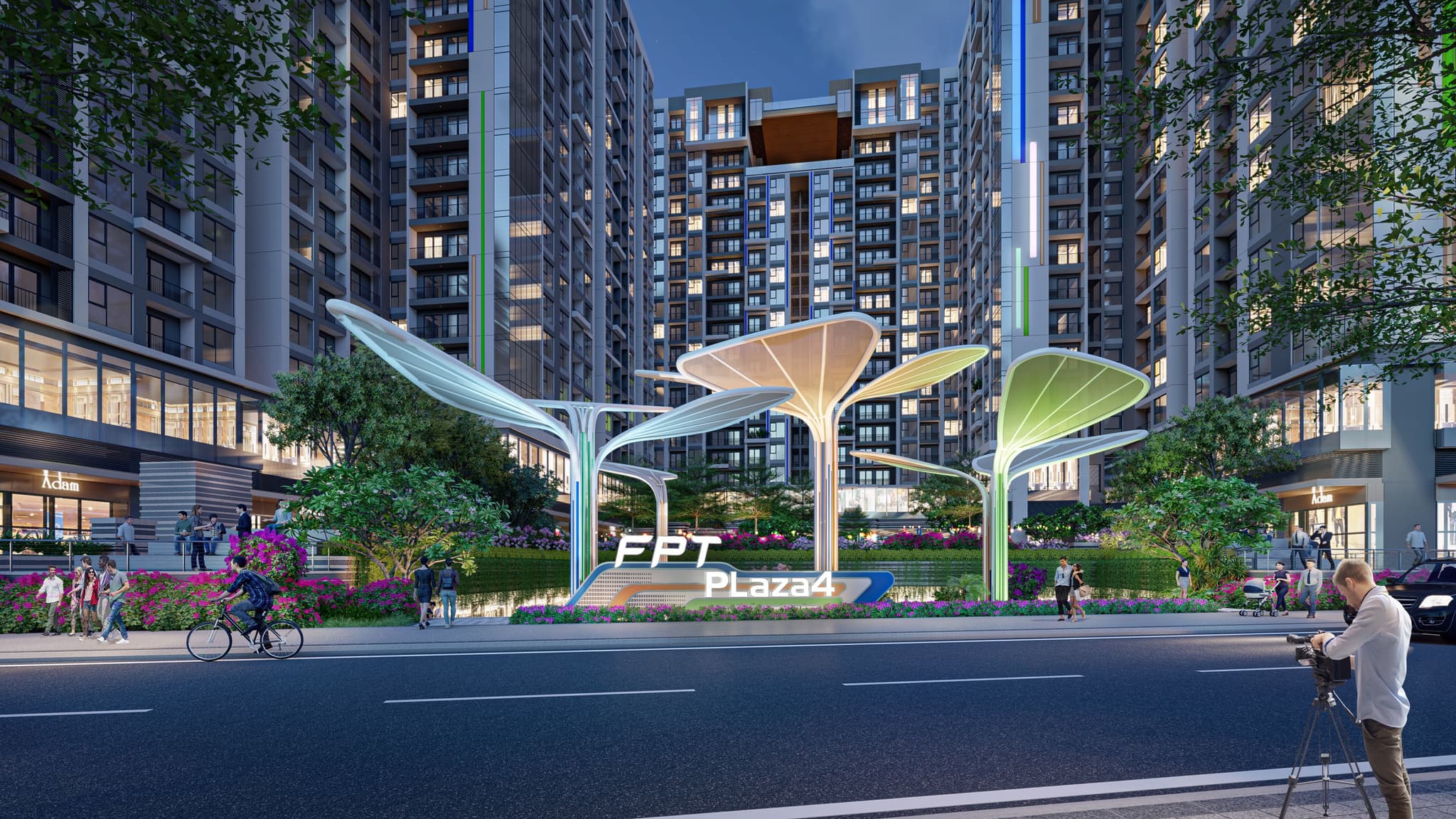 Modern urban landscape featuring FPT Plaza with contemporary architecture, lush greenery, and vibrant flower beds.